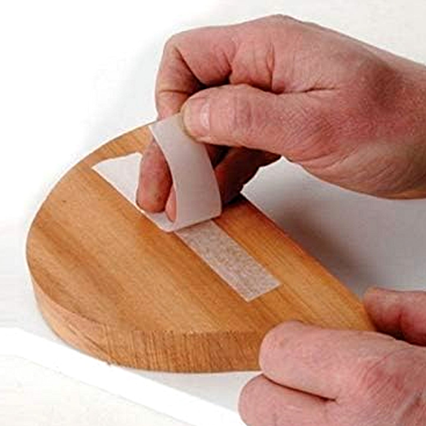 Trend Double Sided Temporary Fixing Tape 50m x 19mm DS/TAPE Being Used on a Piece of Wood