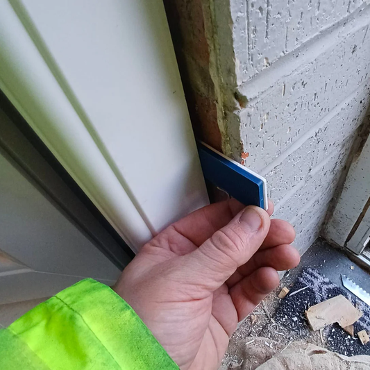 Insatlling a new door in a frame using window packers to ensure it is straight and level