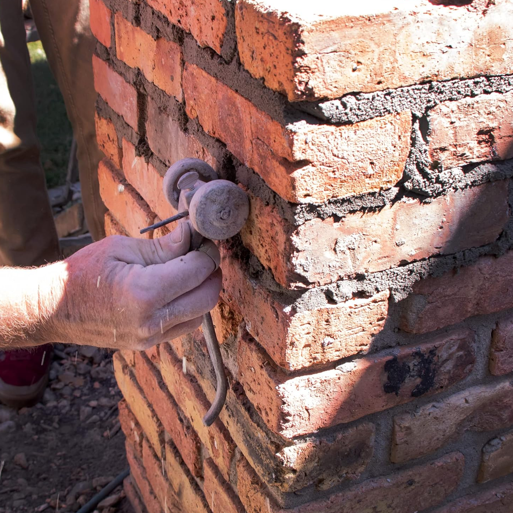 Marshalltown Chariot Brick Joint Mortar Raker - M89 Being used on a wall to rake mortar from the joints
